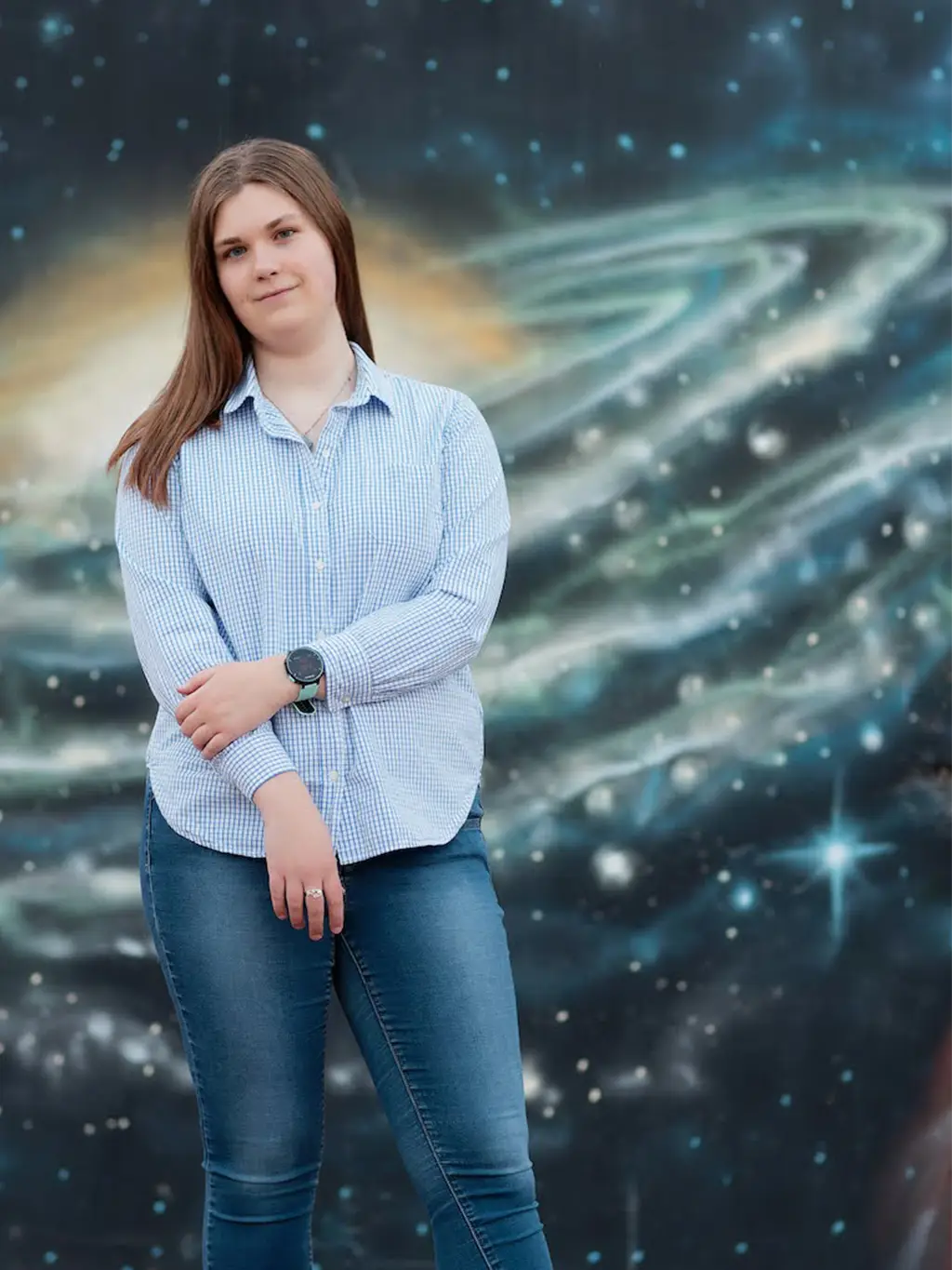 Me, standing in front of a mural painted to look like a spiral galaxy